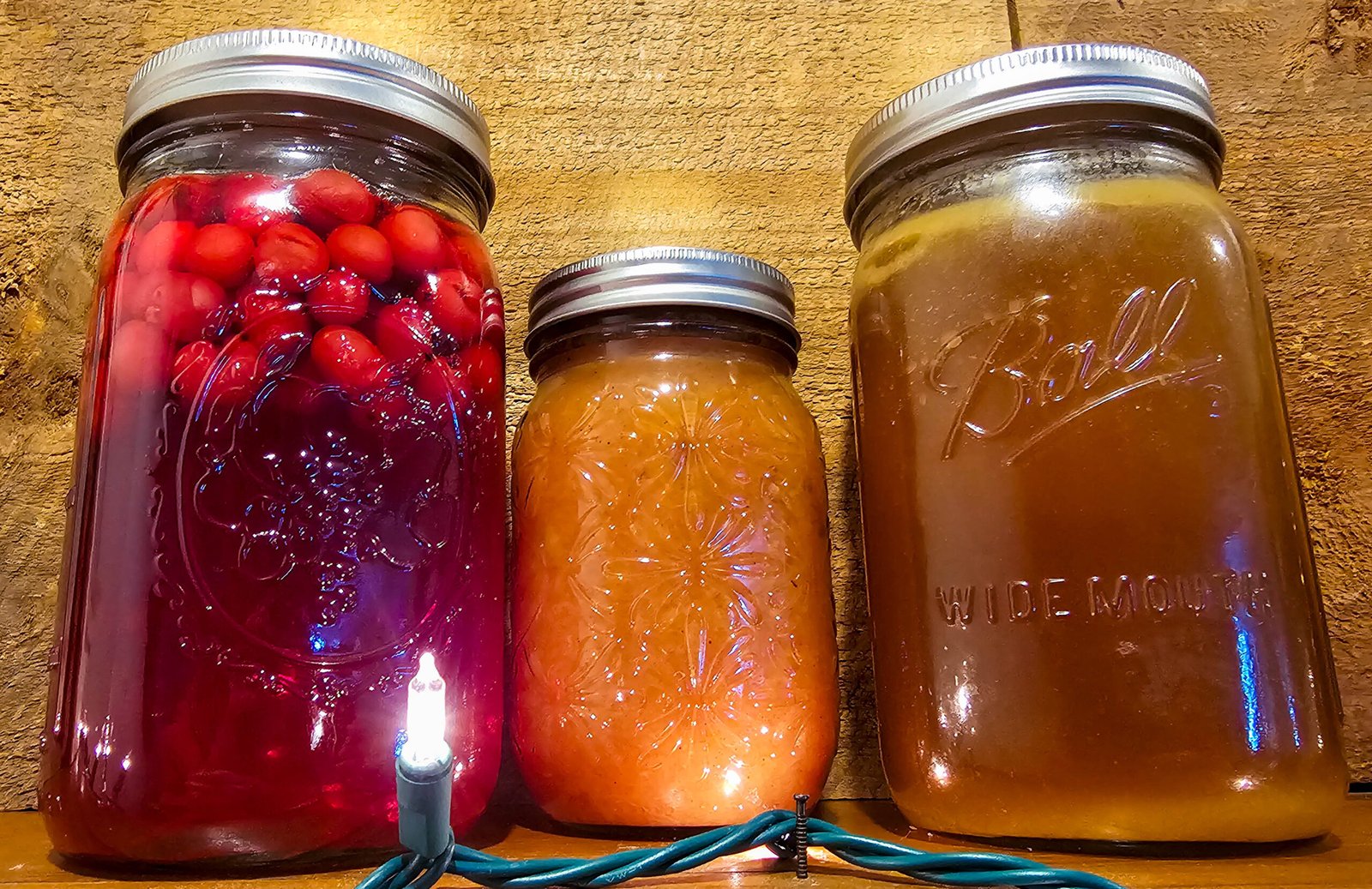 mason jars canned with applesauce, cranberries, and bone broth